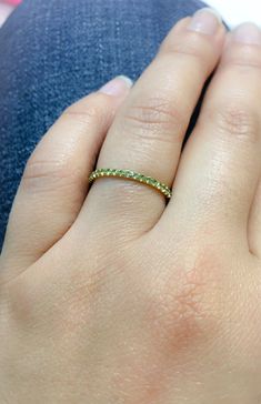 "Full Eternity Band Ring with U Micro Pave Set Natural Genuine Peridot. Material: Solid Gold (14K or 18) Finish: High Polished /Shiny Fit: Comfort Fit (Rounded Interior) Width: 1.8 mm Height: 1.8 mm Setting Type: U Micro Pave (Reminds the letter\"U\") Stone: Natural Green Peridot Cut & Shape: Round, Diamond Cut Total Carat Size: apx 0.70+ ct Quantity of Stones: apx 38 (Varies by ring size) Quality: AAA Peridot has a unique shade of lime green that looks different green depending on inside/ou Green Diamond Stackable Rings With Birthstone, Green Diamond Half Eternity Ring, Green Diamond Stackable Ring, Green Diamond Stackable Ring With Round Cut, Green Diamond Stackable Round Ring, Fine Jewelry Green Stackable Rings With Prong Setting, Green Stackable Diamond Ring With Round Cut, Green Stackable Rings With Prong Setting, Green Stackable Round Diamond Ring