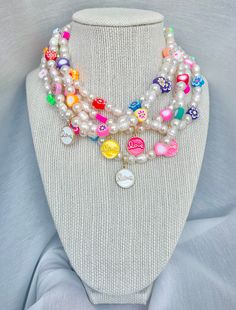 🙂 Sweet Lovin' Necklace 🙂 If pearls are anyone's best friend, this necklace would become your new go to everyday. With a mix of white pearls, freshwater pearls, colorful clay beads in different shapes and a delicate gold filled and enamel charm this necklace is here to brighten your outfit. The "Candy Crush" collection is meant to be for anyone who likes to have a classy yet fun style! Materials: Beaded pearls, freshwater pearls, clay beads  14k Gold filled and enamel charm 18K Gold Filled loc White Charm Necklace With Pearl And Round Beads, White Pearl Charm Necklace With Round Beads, Adjustable White Charm Necklace For Birthday, Adjustable White Charm Necklaces With Letter Beads, White Adjustable Charm Necklace With Letter Beads, Whimsical White Jewelry With Pearl Charm, Trendy White Charm Necklace For Gift, Playful White Charm Necklaces For Gifts, White Charm Necklaces With Colorful Beads For Gift