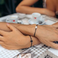 A sentimental and meaningful matching bracelet set for you and your partner. The black and white lava stones represent Ying & Yang - an ancient symbol of harmony and balance, symbolising complementary (rather than opposing) forces that interact to form a dynamic connection. Adjustable size Made from polyester cord and alloy. Includes 2x bracelets (1 white stone & 1 black) Spiritual Couples, Matching Couple Bracelets, Promise Bracelet, String Bracelets, Couples Bracelet, Lava Bracelet, Boho Chic Jewelry, White Bracelets, Meaningful Jewelry