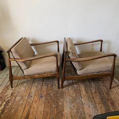 two chairs sitting next to each other on a wooden floor