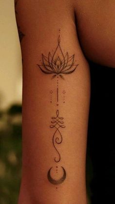 a woman's arm with a lotus tattoo on the left side of her body