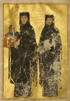 two women standing next to each other in front of a gold and black painting on paper