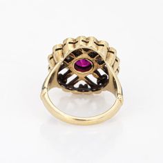 This is part of Chairish’s Fine Jewelry assortment.  Elegant and finely detailed Edwardian era enamel ring (circa 1900s to 1910s), crafted in 14 karat yellow gold.    Created ruby measures 5mm (in very good condition and free of cracks or crisps). Small natural 1mm seed pearls surround the ruby.   A created ruby is set into a beautifully detailed scrolled mount. Blue and black enamel adds a pop of colour, offering contrast to the ruby that is striking and unique. The ring is small in size (2 1/2 Vintage Gold Enamel Ring Stamped 14k, Fine Jewelry Yellow Gold Ruby Ring With Intricate Design, Heirloom Yellow Gold Ruby Signet Ring, Victorian Gold Cluster Ring With Gemstone, Heirloom Ruby Signet Ring In Yellow Gold, Antique Yellow Gold Cluster Ring With Gemstone, Yellow Gold Ruby Ring With Intricate Design, Victorian 14k Yellow Gold Cluster Ring, Gold Ruby Ring With Bezel Setting, Heirloom Style