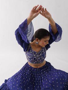 A three-piece Purple lehenga set from the Suruchi Parakh collection. This elegant georgette crepe lehenga is paired with a hand-embroidered blouse. The outfit is completed with a matching georgette crepe dupatta. The bell sleeve blouse has a cutwork neckline. And, the purple dupatta has a beautiful touch of ruffle with an embellished border. Floor-length Georgette Palazzo Set For Transitional Seasons, Transitional Floor-length Georgette Palazzo Set, Traditional Drape Palazzo Set With Unstitched Blouse, Georgette Choli With Mirror Work, Traditional Drape Georgette Sharara For Transitional Season, Georgette Palazzo Set With Cutdana For Reception, Transitional Georgette Blouse Piece With Mirror Work, Semi-stitched Palazzo Set For Reception And Navratri, Georgette Palazzo Set With Cutdana For Navratri