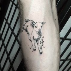 a black and white sheep tattoo on the left leg, it looks like he is running