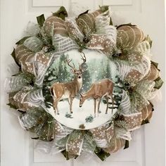 a christmas wreath with two deer on it