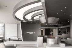 the interior of an office building with curved ceilings