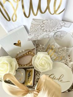 a box filled with lots of white flowers and some gold foil on top of it