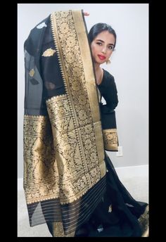 From the fine weaving techniques of Banaras and a stunning color combination this beautiful bootidaar saree in silver and gold zari (sona and Rupa) is an ode to culture.Delicately crafted bootis in Gold & silver zari, woven in the exquisite style on resplendent kora organza . Traditional Banarasi at its finest and most classic kaduwa weaving technique. Color - A mesmerizing shade of blackWeaving Technique - oainstaking kaduwa weaving, passed down genertions Fabric - Silky smooth Pure Kora Organz Traditional Tissue Silk Sharara With Cutdana, Elegant Jamawar Pre-draped Saree For Eid, Elegant Black Salwar Kameez With Cutdana, Elegant Pre-draped Jamawar Saree With Pallu, Traditional Wear With Sheer Dupatta In Tussar Silk, Traditional Semi-stitched Salwar Kameez With Zari Weaving, Black Pre-draped Saree With Zari Weaving For Puja, Traditional Ceremonial Pre-draped Saree With Cutdana, Elegant Art Silk Pre-draped Saree For Traditional Ceremonies