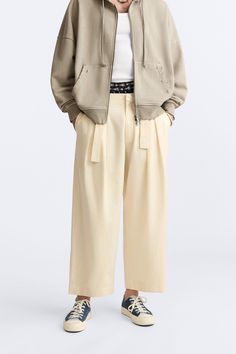 LIMITED EDITION BELTED PANTS Casual Wide Leg Belted Pants, Casual High-waisted Pants With Belted Cuffs, Casual Spring Bottoms With Belted Cuffs, Spring Cotton Parachute Pants For Work, Beige Wide-leg Pants With Belt Loops, Spring Workwear Cotton Parachute Pants, Beige Wide-leg Belted Bottoms, Casual Summer Pants With Belted Cuffs, Beige Belted Wide-leg Bottoms