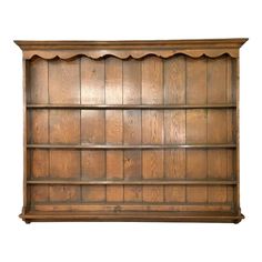 an old wooden bookcase with scalloped shelves