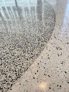 the floor is covered in many different colored pebbles