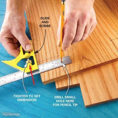 a person using a ruler to measure wood planks