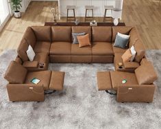 a living room filled with lots of brown furniture