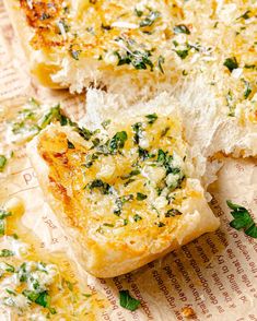 a piece of bread with cheese and herbs on it