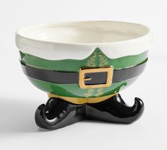 a green and white bowl sitting on top of a black base with a gold buckle