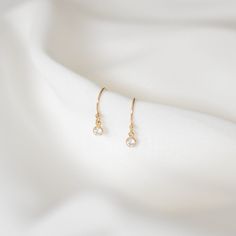 Simple and perfect for everyday wear, these dainty earrings feature a 3mm brilliant dangling cubic zirconia charm. These are all made of 14K gold filled materials and are tarnish-resistant, water-resistant, and hypoallergenic.  Comes with box and jewelry pouch, ready for gifting. --------------------♥ PROMOS ♥-------------------- Want 10% off? Join the mailing list by visiting http://bit.ly/vedern . Just leave me a note at checkout if you have any problems applying discount codes. --------------------♥ BUY WITH CONFIDENCE ♥-------------------- Don't love it? Message me to set up a return or exchange. If you find any problems with your items, just send a message with a photo, and a new one will be on its way to you! --------------------------♥ PACKAGING ♥--------------------------- Gold fil Minimalist Diamond Drop Earrings, Dainty 14k Yellow Gold-filled Earrings, Dainty 14k Yellow Gold Filled Earrings, 14k Gold Diamond Earrings With Ear Wire As Gift, Tiny Gold Elegant Diamond Earrings, Dainty 14k Gold Filled Earrings For Gift, Elegant Gold Diamond Earrings, Tiny Delicate Gold-plated Earrings, Tiny Delicate Gold Plated Earrings