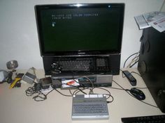 a laptop computer sitting on top of a desk next to a keyboard and mouse,