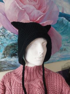 a mannequin wearing a knitted hat with a cat's head