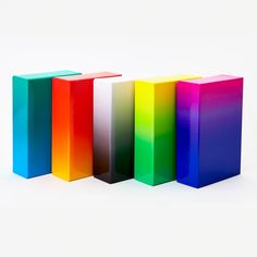 four different colored blocks sitting next to each other