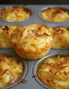 several muffins with cheese and other toppings in a pan