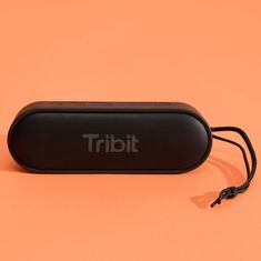 a small black speaker sitting on top of an orange surface with the word trial printed on it