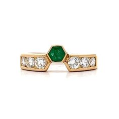 Emerald & Diamond Stacking Ring in 18k Yellow Gold This fun ring features a single emerald in 18k yellow gold with diamond accents.  The emerald has a weight of .17 carats and has a unique hexagon shape.  The emerald is accented by six (6) round brilliant cut diamonds of graduated sizes.  The exquisite diamonds have a color grade of F/G which gives the ring a very luxe look. The 18k yellow gold combined with the emerald and diamonds makes this a very compelling stacking band. PRIMARY STONE Stone: Emerald Shape: Other Weight: .17 ct Measurements: 3.50 mm x 3.50 mm = .17 ct (1) ACCENT STONE Accent Stone: Natural Diamond Color and Clarity: F/G, VS2-SI1 Weight: .32 ct Measurements: 2.8 mm = .08 ct (4) Secondary Accent Stone: Natural Diamond Secondary Measurements: 2.3 mm = .045 ct (2) Secondar Luxury Yellow Gold Open Ring Emerald, Octagon Yellow Gold Emerald Ring With Vvs Clarity, Green Diamond Ring With Single Cut Emerald Shape, Yellow Gold Emerald-cut Ring With Single Cut Diamonds, Green Emerald Cut Diamond Ring With Single Cut Diamonds, Fine Jewelry Emerald Ring With Tension Setting, Octagon Emerald Ring In Yellow Gold With Brilliant Cut, Octagon Brilliant Cut Emerald Ring In Yellow Gold, Yellow Gold Emerald Ring With Brilliant Octagon Cut