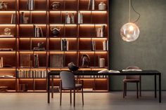 a room with bookshelves, chairs and a table in front of the bookcase