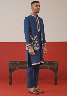 Elevate your style with Blue Jacket kurta set. Crafted from georgette, the jacket showcases exquisite resham and sequinned embroidery. The kurta features a detailed collar, cuffs, and yoke design, plus two pockets and pure lining. Paired with intricately embroidered pants for a touch of elegance. Perfect for special occasions like Sangeet, Mehendi, or as a wedding guest outfit. Composition : Jacket, Kurta & Trouser : Viscose Georgette Care: Dry Clean Only and Vacuum Storage This product can be c Mehendi Outfit For Groom, Vacuum Storage, Embroidered Pants, Indian Wedding Wear, Blue Jacket, Wedding Wear, Wedding Guest Outfit, Indian Wedding, Navy Blue