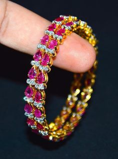 "1 solid 18k gold 10.35cts diamond and ruby bangle f-g color and vs clarity untreated natural diamonds and untreated natural pinkish red rubies. extremely high end - top quality bangle (i have 2 bangles, but this listing is of one bangle. please contact me if you are interested in both bangles) here is the description of one bangle: this is a custom made top quality ruby and diamond bangle. the bangle is loaded with 1.71cts of round brilliant cut diamonds and 22 pear cut natural red rubies total Diamond Yellow Gold Bangle With 17 Jewels, Yellow Gold Diamond Bangle With 17 Jewels, Yellow Gold Diamond Bangle With Jewels, Elegant Diamond Bangle With Gemstones, Diamond Bangle Fine Jewelry, Fine Jewelry Diamond Bangle With Prong Setting, Diamond Bangle In Yellow Gold For Party, Diamond Bangle With Prong Setting, Yellow Gold Diamond Bangle For Party