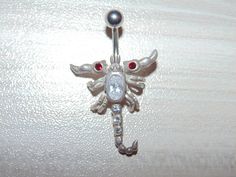 "Link to store: https://www.etsy.com/shop/VintageJewelryEden SOLD SEPARATELY New Handmade Belly button ring Shape: Moveable Scorpion / Leaping Dolphins(sold) / Iguana Lizard / Clear and Blue Spiders Barbell is standard 14 gauge, 3/8\" long made of hypoallergenic surgical stainless steel Dangle elements are sterling silver, stamped 925 All crystal cubic zirconia Colors: Various SHIPPING WORLDWIDE" Scorpion Belly Button Ring, Silver Jeweled Body Jewelry Gift, Silver Jeweled Body Jewelry For Gifts, Adjustable Silver Jeweled Body Jewelry, Adjustable Rhinestone Body Jewelry Gift, Adjustable Rhinestone Body Jewelry For Gift, Snake Belly Button Piercing, Piercing Inspiration, Piercing Bar