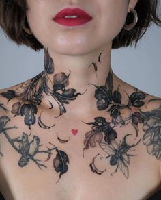 a woman with tattoos on her chest and neck