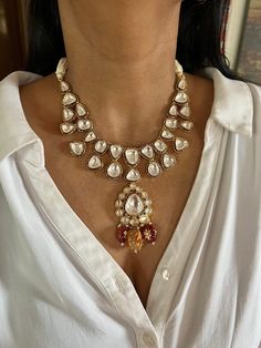 All our pieces are in stock and will be dispatched within 24 to 48 hours of order. Orders received during the weekend will be dispatched on Monday One of our favorite picks for the wedding season ❤️ The Tanjore artwork beads at the bottom of the necklace adds a perfect glamour to the stunning piece. Dimensions Weight of Necklace is 90 g. Drop Length of Necklace: 10 inches Necklace comes with adjustable Dori. Weight of earrings is 16 g per pair. Drop Length of earrings: 4 cms, Push back closure. Handmade Kundan Pearl Necklace Gift, Teardrop Jewelry With Intricate Design For Wedding, Teardrop Wedding Jewelry With Intricate Design, Handmade Kundan Pearl Necklace For Jewelry Making, Pearl Necklace With 17 Jewels For Weddings And Festivals, Unique Pearl Drop Necklace For Wedding, Elegant Teardrop Jewelry For Ceremonial Occasions, White Intricate Dangle Jewelry, Elegant Teardrop Jewelry For Ceremonies