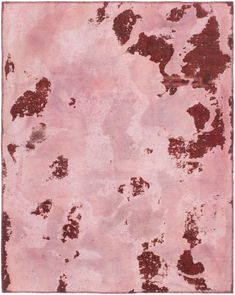 a pink rug with brown spots on it