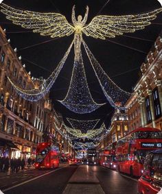 christmas lights adorn the streets of london's famous shopping district, which is decorated with angel wings