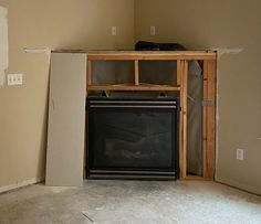 an empty room with a fireplace in it