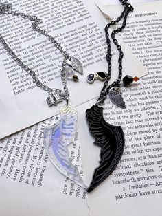 Crowley and Aziraphale are the best so I had to make them, best friend's necklaces. They are perfect to give to your friend or wear both of them. They each feature a now made of Acrylic charm of a wing. Azi is iridescent and Crowley's is black. Both are made by me. Crowley's has a black wing, a pair of hand-painted glasses, and a bead in black and red. He also has his partners in crime charm. Comes on a black chain. Aziraphale has an iridescent he has book charm, a bead in silver and gold with t Personalized Black Bohemian Jewelry, Handmade Black Jewelry For Best Friend Gift, Book Charm, Bff Necklace, Crowley And Aziraphale, Bff Jewelry, Hand Painted Glasses, Perfect Husband, Bff Necklaces