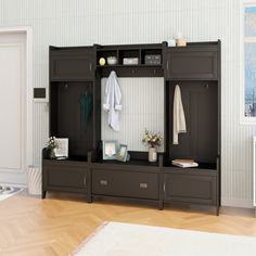 a room with a white rug and some black cabinets