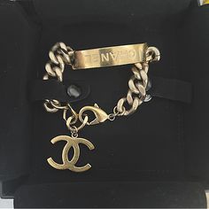 Gold Plated Chunky Chain Bracelet With “Chanel” Imprinted On Plate. Has A Lobster Clasp Therefore It Is Adjustable. Has A Large Cc That Hangs From The End Of Bracelet When Clasped. It Is Stunning. Remains Vibrant. Slight Sense Of Use With Superficial Scratches Throughout As Seen However Remains In Very Good Condition And Gold Is Vibrant. Comes In Pouch And Box. Authenticated, However Posh Will Authenticate In House On Purchases Over $500. Hard To Come Across In This Condition. It Is Gorgeous!!! Designer Metal Bracelets With Logo Charm, Designer Metal Chain Bracelets, Designer Gold Metal Chain Bracelet, Designer Gold Chain Bracelet, Designer Gold Bracelets With Logo Charm, Luxury Engraved Metal Chain Bracelet, Luxury Metal Curb Chain Bracelet, Luxury Metal Jewelry With Logo Charm, Designer Gold Chain Bracelets