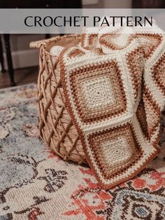 a crocheted basket sitting on top of a rug