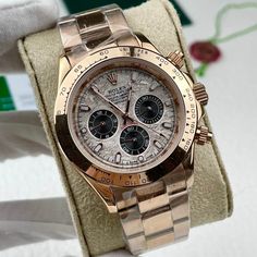 This exquisite timepiece is a Rolex Cosmograph Daytona, a legendary model celebrated for its connection to motorsports and timeless design. Crafted entirely from Rolex's proprietary Everose gold, this watch exudes luxury and warmth. The dial showcases a mesmerizing meteorite pattern, a unique and rare feature that adds a touch of cosmic wonder to this exceptional timepiece. Black chronograph sub-dials provide a striking contrast against the meteorite background, further enhancing its visual appe Gold Luxury Chronograph Watch With Skeleton Dial, Rolex Daytona Rainbow Rose Gold, Rolex Daytona Two Tone, Rolex Daytona Gold Green Dial, Rolex Daytona Watch, Rolex Daytona Oysterflex Gold, Rolex Cosmograph Daytona, Cosmograph Daytona, Mechanical Movement