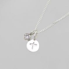 "Handcrafted sterling silver necklace with a stamped cross. Comes on your choice of a 16 or 18 inch sterling silver chain with the artist's tag attached at the clasp. (Shown on a 16\" chain) Makes an excellent gift. Can be worn a number of ways. Add more some birthstone drops for a more personal touch! To add a birthstone drop pendant, go to: https://www.etsy.com/listing/127617405/birthstone-drop-pendant-sterling-silver?ga_search_query=birthstone+drop+pendant&ref=shop_items_search_3" Inspirational Sterling Silver Nickel-free Charm Necklaces, Inspirational Sterling Silver Nickel-free Charm Necklace, Cross Necklace With Charms As Gift, Sterling Silver Cross Pendant Necklace With Charms, Sterling Silver Necklaces With Cross Pendant Charms, Dainty Sterling Silver Cross Pendant Charm Necklace, Spiritual Sterling Silver Hand Stamped Necklaces, Sterling Silver Charm Necklace With Cross Pendant, Sterling Silver Cross Charm Necklace