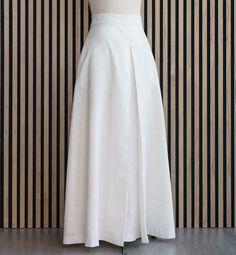 Long linen skirt with pockets and high waistband in ecru. The A-line skirt is a wide skirt perfect for special occasions. It has a nice pleat on the front. Skirt with cotton lining.  Skirt length: 110 centimeters                        43,3 inches Care recommendations: Cold water washing (no more than 30 degrees Celsius) is preferred, as well as machine washing in delicate mode. Use mild detergents. Don't use bleach. Do not tumble dry. Cream Long Pleated Lined Skirt, Cream Pleated Long Skirt, Long Cream Skirt With Gathered Detail, Cream Long Skirt With Gathered Detail, Relaxed A-line Pleated Skirt With Pockets, Pleated A-line Skirt With Pockets, Long Cream Relaxed Skirt, Fitted White Lined Wrap Skirt, Cream Long Relaxed Skirt