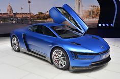 a blue sports car is on display at an auto show