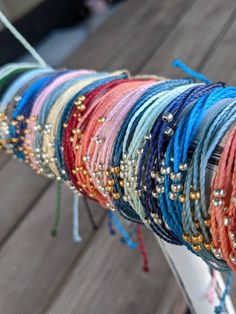 P U R A V I D A B R A C E L E T these pura vida inspired bracelets are made so that you can have a similar bracelet for cheaper! these are durable, so you do not have to worry about the string breaking. these bracelets are waterproof, so you can wear them in the water and are also adjustable, so you do not have to worry about the fit. these bracelets are made extra-long, so that one size can fit all. however, if the ends are too long for your taste, you can simply cut, tie, and burn the ends. ea Trendy Adjustable Friendship Bracelets With Gold Beads, Trendy Adjustable Gold Beads Friendship Bracelets, Summer Friendship Bracelets With Tiny Beads As Gifts, Summer Gift Friendship Bracelets With Tiny Beads, Friendship Bracelet With Gold Beads, Adjustable Colorful Friendship Bracelets With Beads, Adjustable Colorful Friendship Bracelets, Colorful Adjustable Friendship Bracelets With Beads, Adjustable Colorful Friendship Bracelets With Tiny Beads