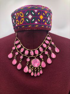 The pink stone necklace has three-layers which flaunting all the classic vibes. It is delicately crafted in a basic tribal style, whilst retaining the best stability of ethnic and modish touch. The beautiful necklace has wooden and metallic beads, assembled inside every string of the necklace alongside with a dangling pendant in the middle, complementing the tribal fashion of the ornament. The necklace is made with great metallic alloy, plated with golden rustic hues. Pair this amazing piece wit Pink Stone Necklace, Afghan Jewelry, Bib Necklaces, Layered Necklace, Bib Necklace, Beautiful Necklace, Pink Stone, Necklace Handmade, Beaded Chain