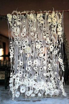 an art installation made out of plastic skulls and string