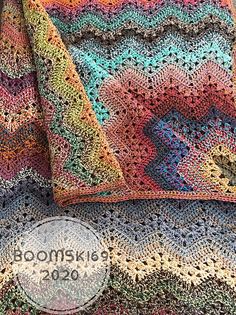 a crocheted blanket and pillow on top of each other