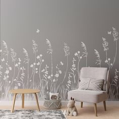 a living room with grey walls and white flowers on the wall, a small child's toy sits next to it