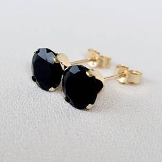 Embrace timeless sophistication with our genuine black onyx stud earrings. The deep, velvety black of onyx exudes a sense of mystery and elegance. Meticulously crafted for understated beauty, these studs add a touch of classic refinement to any ensemble. Elevate your style with the enduring charm of black onyx, a versatile and stylish addition to your jewelry collection. Two round genuine 6mm black onyx studs. These classic earrings are available in your choice of a 14K gold-filled setting, 14k Classic Black Jewelry As Gift, Classic Black Jewelry For Gift, Black Pierced Earrings In Fine Jewelry Style, Black Fine Jewelry For Everyday, Classic Black Jewelry For Everyday, Classic Black Earrings, Tarnish Resistant Black Earrings For Gift, Minimalist Black Earrings For Anniversary, Black Tarnish Resistant Earrings For Gift